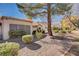 Landscaped backyard with gravel, bushes, and a view of the house's back at 9320 Quail Ridge Dr, Las Vegas, NV 89134