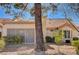 Rear view of house showing patio, landscaping, and a large tree at 9320 Quail Ridge Dr, Las Vegas, NV 89134