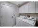 Laundry room with washer, dryer, and overhead cabinets at 9320 Quail Ridge Dr, Las Vegas, NV 89134