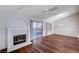 Bright living room with fireplace, wood floors, and sliding glass door to patio at 9320 Quail Ridge Dr, Las Vegas, NV 89134