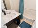 Bathroom with dark vanity, teal shower curtain, and bathtub at 9332 Newbattle St, Las Vegas, NV 89178