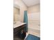 Bathroom with dark vanity, teal shower curtain, and bathtub at 9332 Newbattle St, Las Vegas, NV 89178