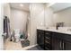 Bathroom with double vanity, large mirror, and tub at 9332 Newbattle St, Las Vegas, NV 89178