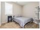 Small bedroom with gray bedding, carpet, and built-in shelving at 9332 Newbattle St, Las Vegas, NV 89178