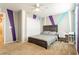 Bright bedroom with gray carpet, built-in desk, and accent wall at 9332 Newbattle St, Las Vegas, NV 89178