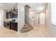 Bright entryway featuring tile floors, carpeted stairs to the second story, and access to the kitchen at 9332 Newbattle St, Las Vegas, NV 89178