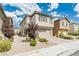 Two-story home featuring beige stucco, brown shutters, desert landscaping and a two car garage at 9332 Newbattle St, Las Vegas, NV 89178