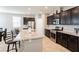 Modern kitchen with granite countertops, island with seating, and stainless steel appliances at 9332 Newbattle St, Las Vegas, NV 89178