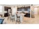 Modern kitchen with an island, dark cabinetry, and stainless steel appliances at 9332 Newbattle St, Las Vegas, NV 89178