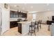 Modern kitchen with dark cabinetry, granite countertops, stainless steel appliances, and an island at 9332 Newbattle St, Las Vegas, NV 89178