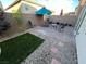 Small patio with artificial turf, seating area, and umbrella at 9332 Newbattle St, Las Vegas, NV 89178