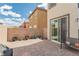 Charming brick patio with potted plants and sliding glass door access at 9332 Newbattle St, Las Vegas, NV 89178