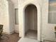 Inviting entryway with arched doorway and neutral exterior at 2119 Pebble Creek Ln, Laughlin, NV 89029