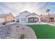Artificial turf, rock landscaping and covered patio with lounge chairs at 1215 Country Club Dr, Laughlin, NV 89029