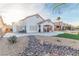 Artificial turf, rock landscaping and covered patio with lounge chairs at 1215 Country Club Dr, Laughlin, NV 89029