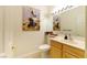 Clean bathroom with wood vanity and framed art at 1215 Country Club Dr, Laughlin, NV 89029