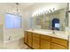 Double vanity bathroom with large mirror and soaking tub at 1215 Country Club Dr, Laughlin, NV 89029