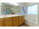 Double vanity bathroom with large mirror and soaking tub at 1215 Country Club Dr, Laughlin, NV 89029