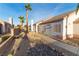 Landscaped walkway to the side of a charming single story home at 1215 Country Club Dr, Laughlin, NV 89029