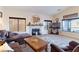 Living room with a fireplace, large windows, and comfortable seating at 1215 Country Club Dr, Laughlin, NV 89029