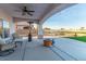 Covered patio with fire pit and comfortable seating at 1215 Country Club Dr, Laughlin, NV 89029