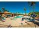 Community pool featuring a spa, lounge chairs and tropical landscaping at 1215 Country Club Dr, Laughlin, NV 89029