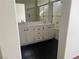 Double sink bathroom with a shower and dark floor at 16 Belle Essence Ave, Las Vegas, NV 89123