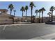 Parking area with community pool and palm trees at 16 Belle Essence Ave, Las Vegas, NV 89123