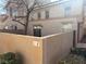 Tan colored stucco building with a small patio at 16 Belle Essence Ave, Las Vegas, NV 89123