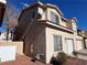 Rear view of two-story stucco home with attached garage at 16 Belle Essence Ave, Las Vegas, NV 89123