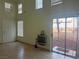 Living room with high ceilings, electric fireplace, and sliding door to patio at 16 Belle Essence Ave, Las Vegas, NV 89123