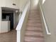 Wood stairs leading to the second floor of the home at 16 Belle Essence Ave, Las Vegas, NV 89123