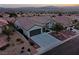 Single-story home with a three-car garage and landscaped yard at 1999 Oliver Springs St, Henderson, NV 89052