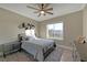 Bedroom featuring ceiling fan, wood flooring, and large window at 1999 Oliver Springs St, Henderson, NV 89052