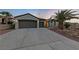 Two-car garage and attractive landscaping at this home at 1999 Oliver Springs St, Henderson, NV 89052