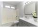 Bathroom featuring a shower-over-tub and gray vanity at 2024 Smoketree Village Cir, Henderson, NV 89012