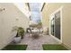Private backyard patio with seating area, grill, and artificial turf at 2499 Adige Pl, Henderson, NV 89044