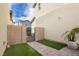 Private backyard with artificial turf and gate at 2499 Adige Pl, Henderson, NV 89044