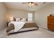 Cozy bedroom featuring plush carpet, a ceiling fan, and a large bed with soft, neutral-toned bedding at 2499 Adige Pl, Henderson, NV 89044