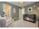 Inviting bedroom includes a black crib, chair, and soothing paint at 2499 Adige Pl, Henderson, NV 89044