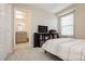 Neutral-colored bedroom with a view to a bright bathroom with double sinks at 2499 Adige Pl, Henderson, NV 89044