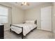 Guest bedroom featuring neutral walls, gray carpet, a ceiling fan and a bed with a metal frame at 2499 Adige Pl, Henderson, NV 89044