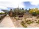 Inviting community entrance featuring decorative stone signage, well-maintained landscaping, and pedestrian walkways at 2499 Adige Pl, Henderson, NV 89044