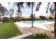 Inviting community pool featuring ample seating, umbrellas for shade, and a grassy area, perfect for relaxation at 2499 Adige Pl, Henderson, NV 89044