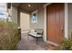 Welcoming front porch featuring a comfortable bench, stylish accents, and a lovely entrance at 2499 Adige Pl, Henderson, NV 89044