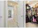 Hallway with a view to the bedroom and open door to a walk-in closet with ample storage space at 2499 Adige Pl, Henderson, NV 89044