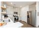 Bright kitchen with stainless steel appliances, shaker cabinets, and quartz countertops at 2499 Adige Pl, Henderson, NV 89044