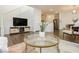 Bright living room features a modern aesthetic, wood floors, and neutral color palette at 2499 Adige Pl, Henderson, NV 89044