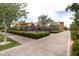 Playground area featuring shade structures, playground equipment, and lush green landscaping along a paved pathway at 2499 Adige Pl, Henderson, NV 89044