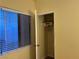 Small bedroom with a closet and window with blinds at 2611 Aracatuba Ave, Las Vegas, NV 89121